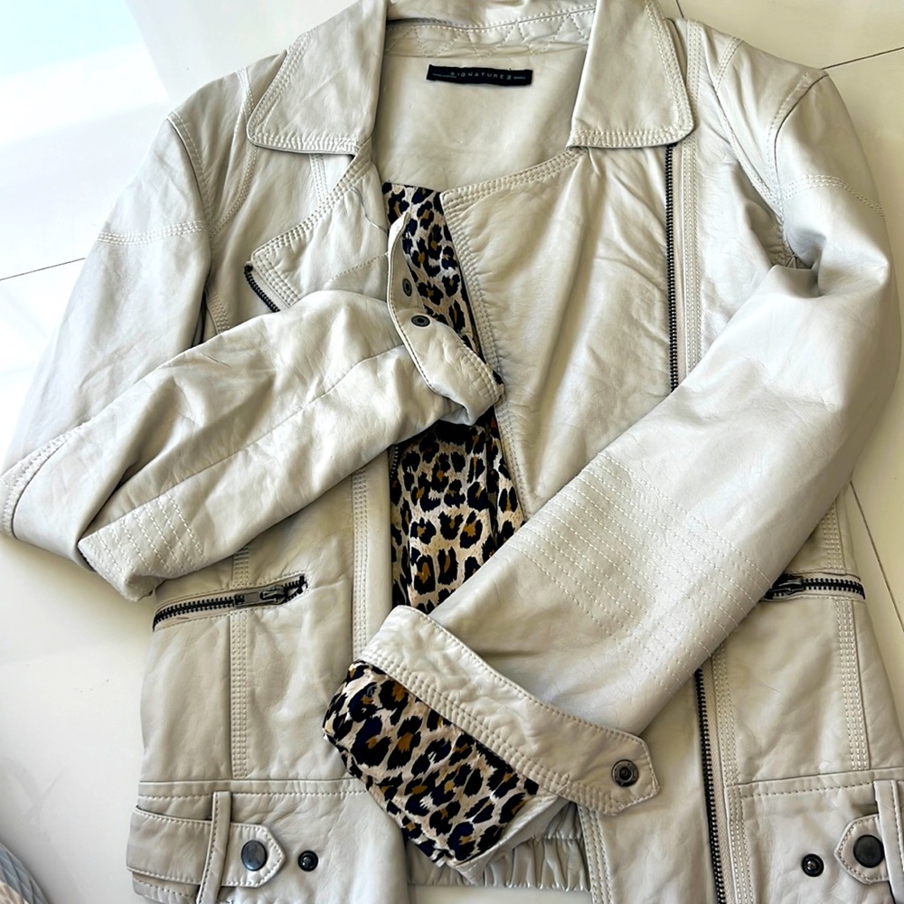 Leather jacket with animal print inside. Slight tear/creases end of sleeve